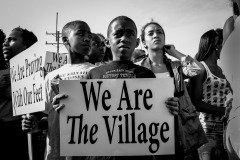 ST LOUIS, MISSOURI - AUG 12, 2014 Young kids who live in the neighborhood hold signs in St Louis, Missouri, August 12, 2014