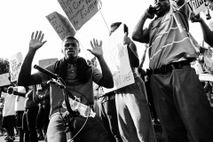 ST LOUIS, MISSOURI - AUG 12, 2014 A young man holds his hands in the air in St Louis, Missouri, August 12, 2014