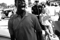 ST LOUIS, MISSOURI - AUG 12, 2014 A young black man yells in outrage after the shooting death of Mike Brown in St Louis, Missouri, August 12, 2014