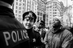 CHICAGO, IL. Nov. 27, 2015 – Pandemonium momentarily ensues as the Chicago police attempt to remove demonstrators from blocking the entrance, and attempted to enter, the Apple Store on North Michigan Avenue during a Black Friday demonstration. The protest was in response to the shooting death of 17-year-old Laquan McDonald by Chicago police Officer Jason Van Dyke in 2014.