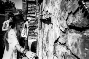 A young lady places an offering upon the mausoleum of the renowned Voodoo priestess, Marie Laveau, in Saint Louis Cemetery No. 1.