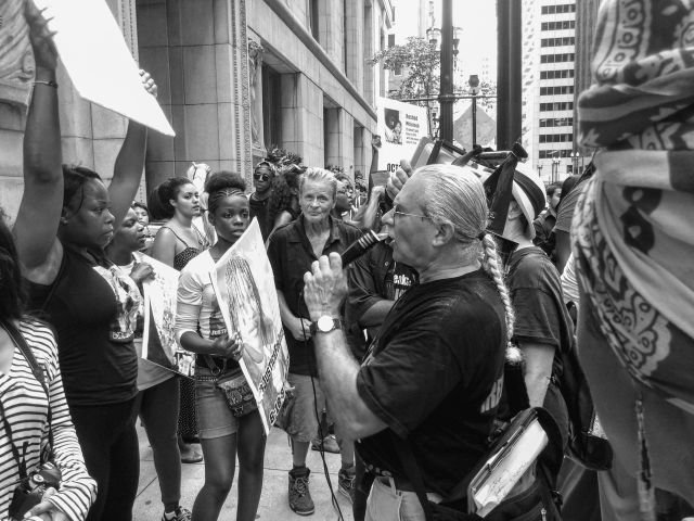 CHICAGO, IL. Aug. 17, 2015 - A cult member of the Bob Avakian Communist Party speaks to a small crowd of people outside of Chicago's City Hall, during a political action that was hosted by Stop Mass Incarceration Network Chicago. Stop Mass Incarceration Network was founded in 2011 by Dr. Cornel West and Carl Dix. Today's action was intended to promote an upcoming event titled "#RiseUpOctober, Which side are you on?" that is to take place in New York City on October 22, 2015.
