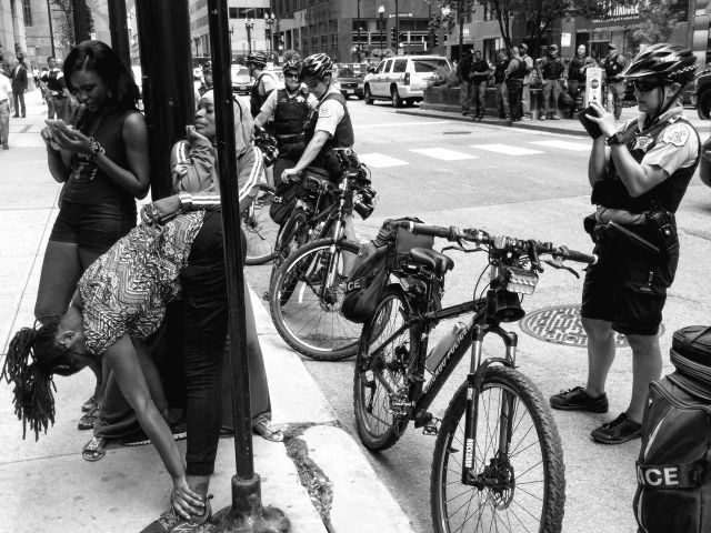 CHICAGO, IL. Aug. 17, 2015 - After much yelling and repeatedly sticking her middle finger in the faces of Chicago Police Officers, this young protester decided to show her thinking end to the Chicago police.