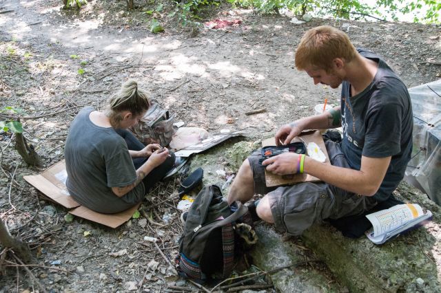 CHICAGO, IL. Sep 6, 2015 - In a place know as "Tent City," located along the bank of the Chicago River not far from Chicago's financial district, heroin addicts, Caleb Higgins, age 26 (right), and Mandrell White, age 34 (left), prepare the gear they'll need to cook the heroin before injection.