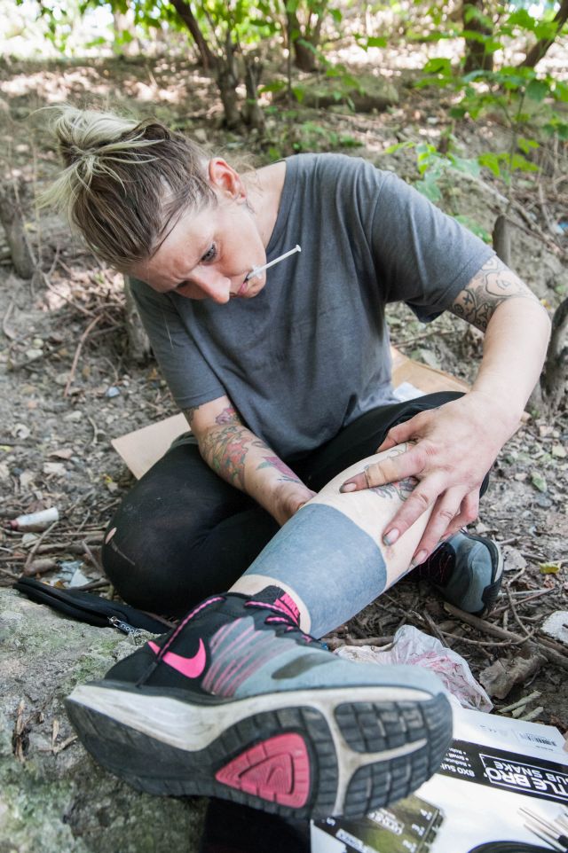 CHICAGO, IL. Sep 6, 2015 - "I know it's hard telling young people not to try heroin because they think they're invincible, and that they'll never get addicted," says longtime heroin addict, Mandrell White, age 34, as she searches for a vein in witch to inject heroin, "but I'm here to tell you - don't mess with heroin."