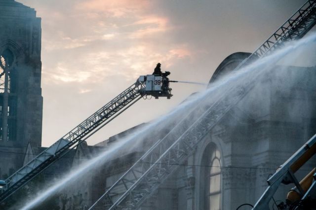 Chicago firefighters battle a blaze at the historic Shrine of Christ the King Catholic Church in the 6400 block of Woodlawn Avenue, on October 7, 2015.