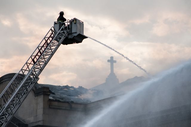 Fire crews pump large volumes of water through the roof of the Shrine of Christ the King Catholic Church on Chicago's Woodlawn Avenue as they attempt to bring a three-alarm fire under control on October 7, 2015.