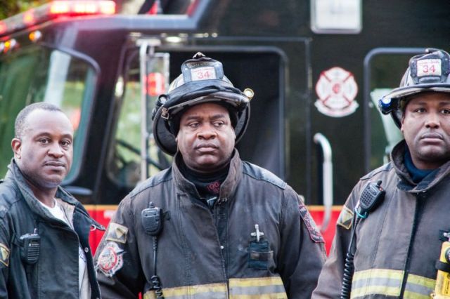 Chicago firefighters gaze at the destruction after gaining control of a fire at the historic Shrine of Christ the King Catholic Church in the 6400 block of Woodlawn Avenue, on October 7, 2015.