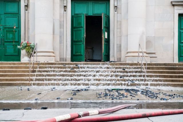 Water cascades down the steps of the Shrine of Christ the King Catholic Church in the 6400 block of Woodlawn Avenue, due to a three alarm fire which broke out at the historic Chicago church on October 7, 2015.