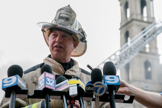 Deputy Fire Commissioner, John McNicholas, gives a press conference outside the heavily damaged 92-year-old Christ the King Catholic Church located in the Woodlawn neighborhood of Chicago on October 7, 2015.