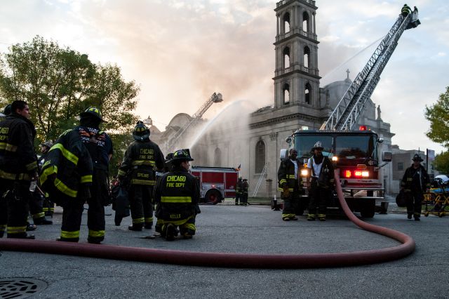 Chicago firefighters battle a blaze that broke out during the early morning hours at the 92 year-old historic Shrine of Christ the King Catholic Church in the 6400 block of Woodlawn Avenue, on October 7, 2015.
